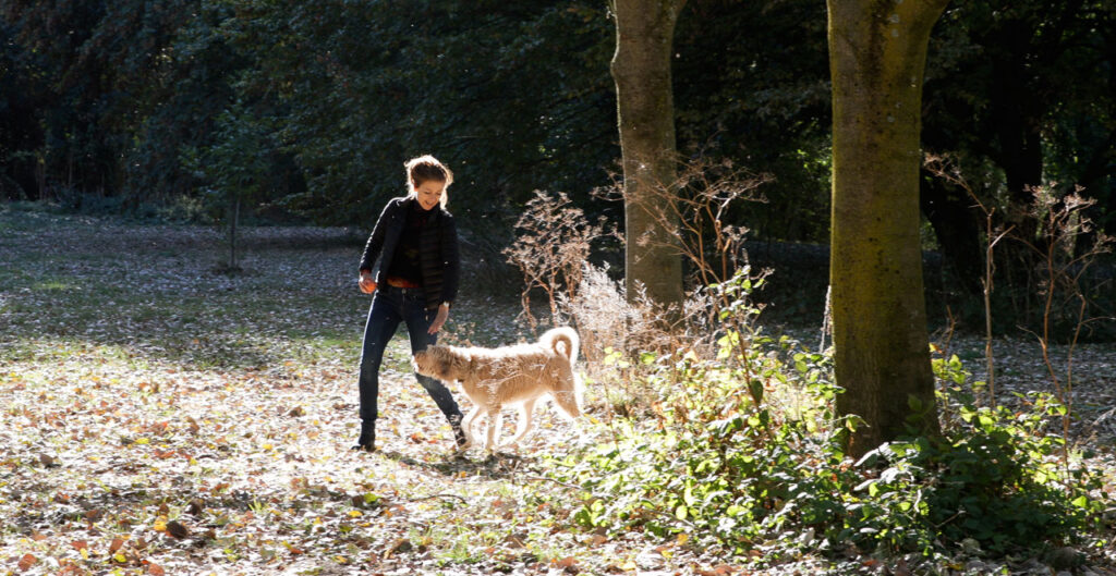 Iris Pohl with her dog Leah in forest